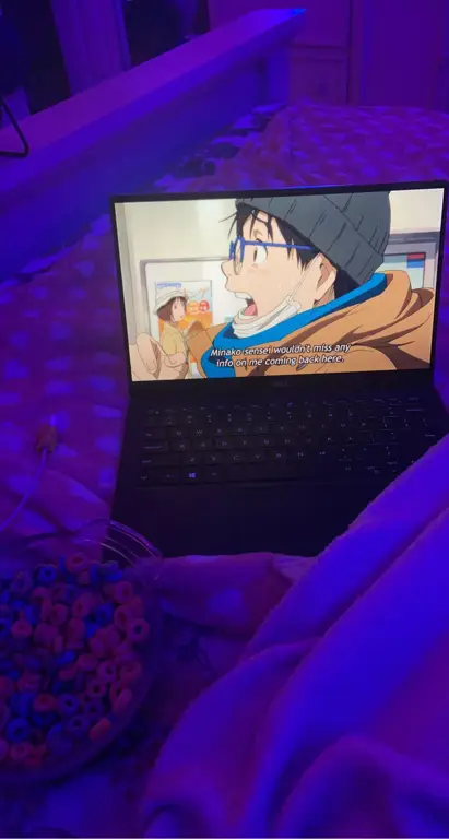Mudahnya Menonton Anime di Mana Saja Seseorang sedang asyik menonton film anime di laptopnya.